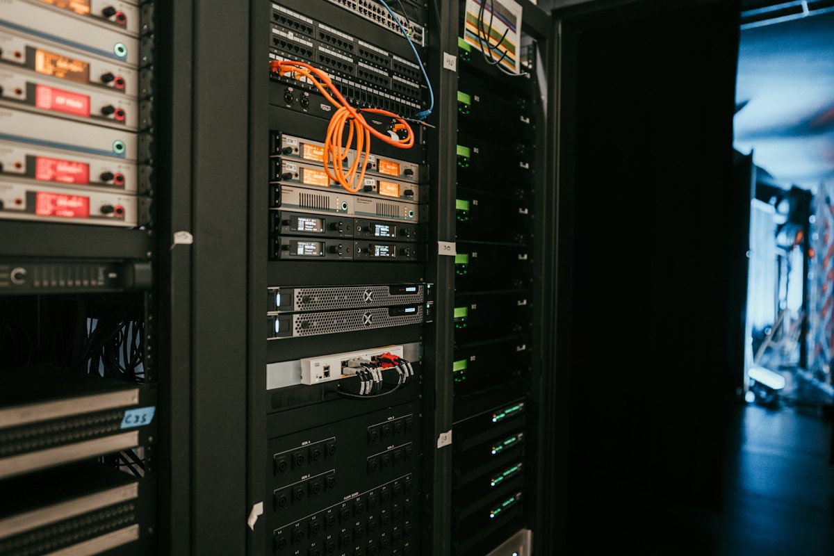Rows of network cables and lit ports in a server rack