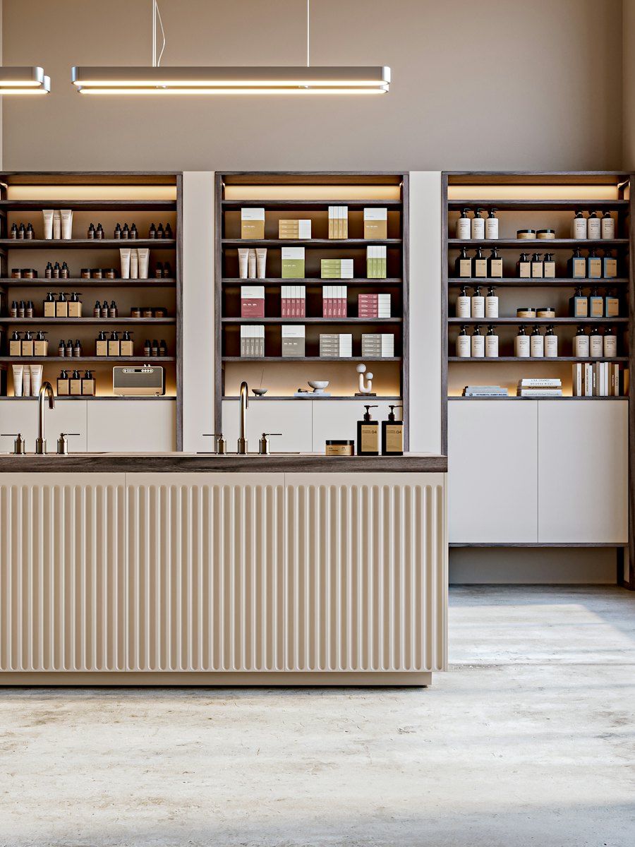 Lit shelving lined with rows of unbranded products above a counter