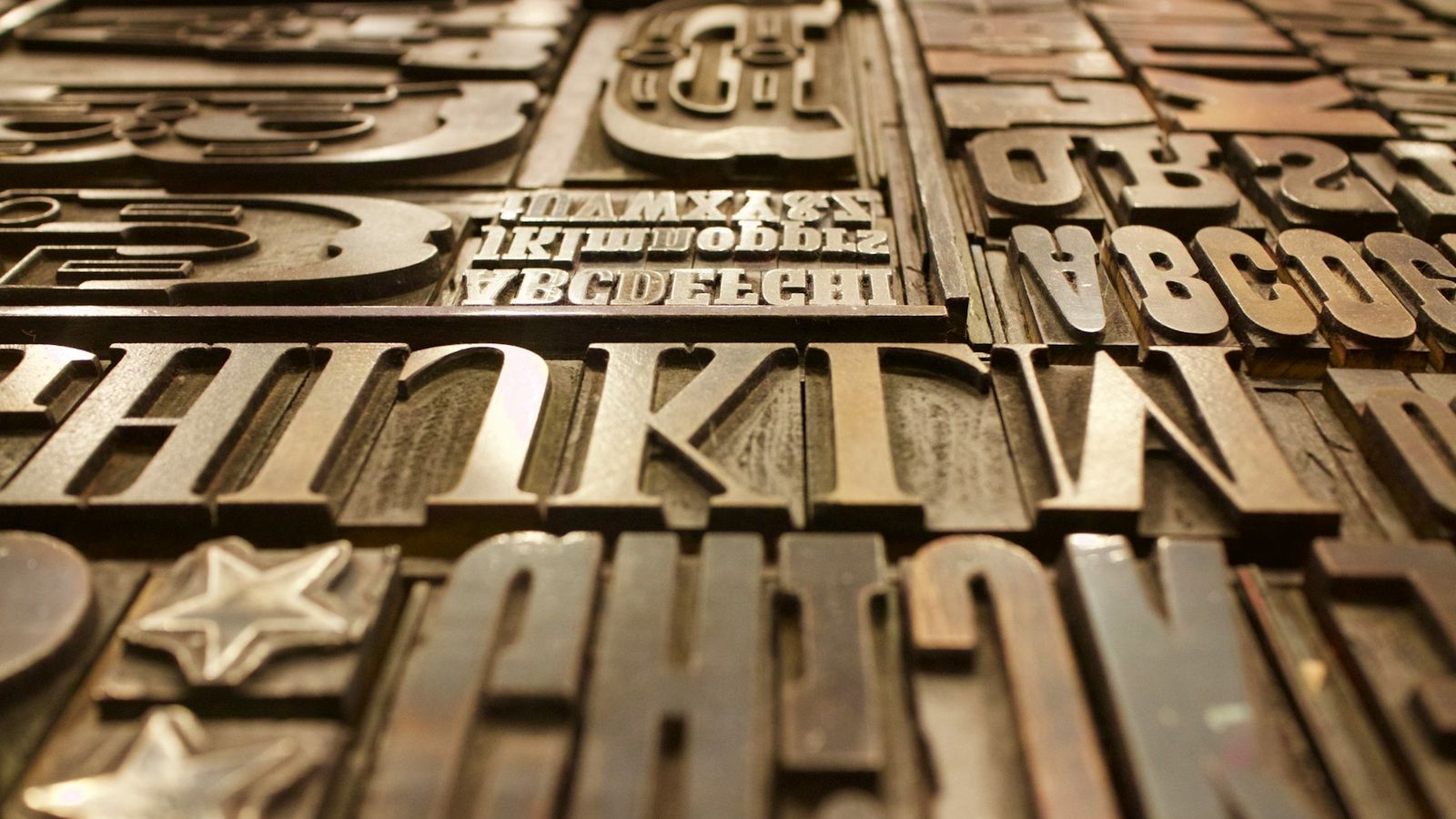 Close-up of worn wooden and metal printing type in a case