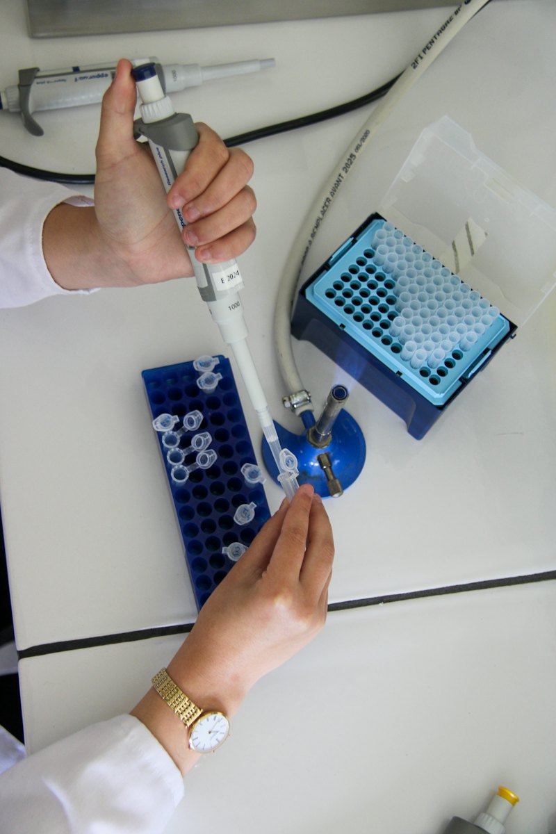 A scientist using a pipette in a laboratory