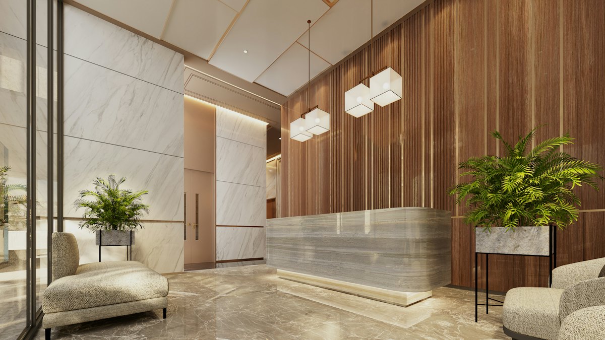 A modern hotel lobby with a marble reception desk