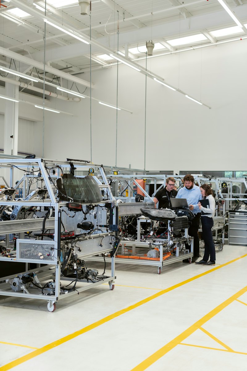 Engineers working on the floor of a manufacturing plant