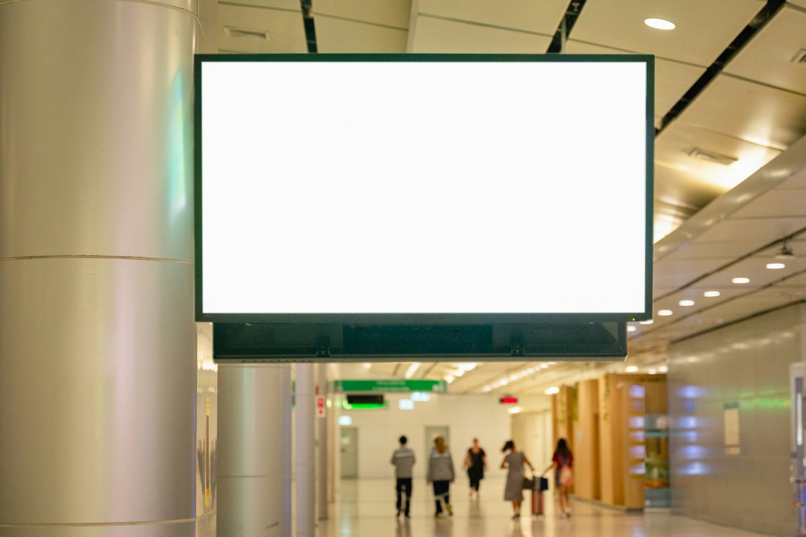A blank lightbox sign in a bright transit hall
