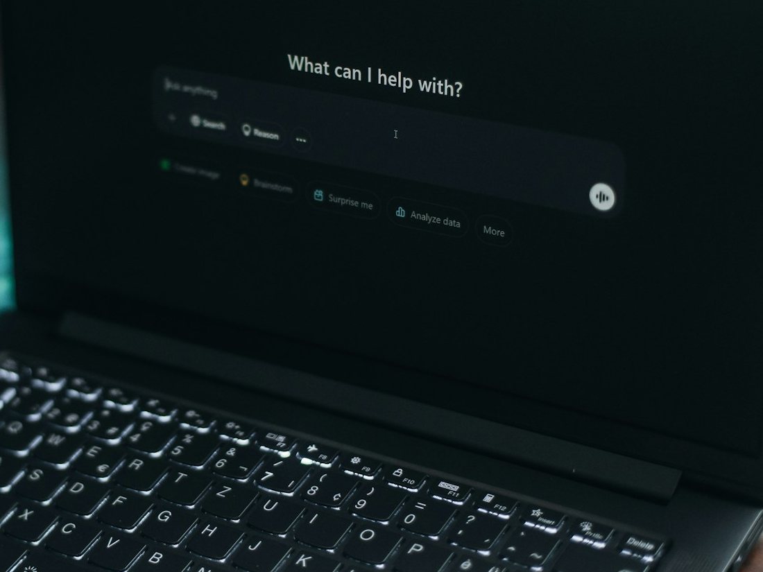 A laptop screen showing an AI assistant's question box.