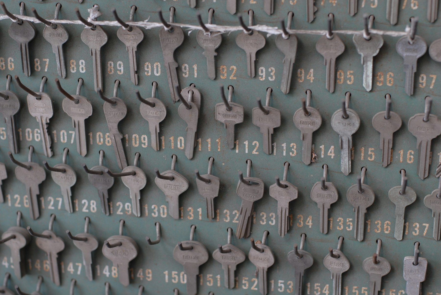Rows of numbered keys hanging on a board, each on its own hook