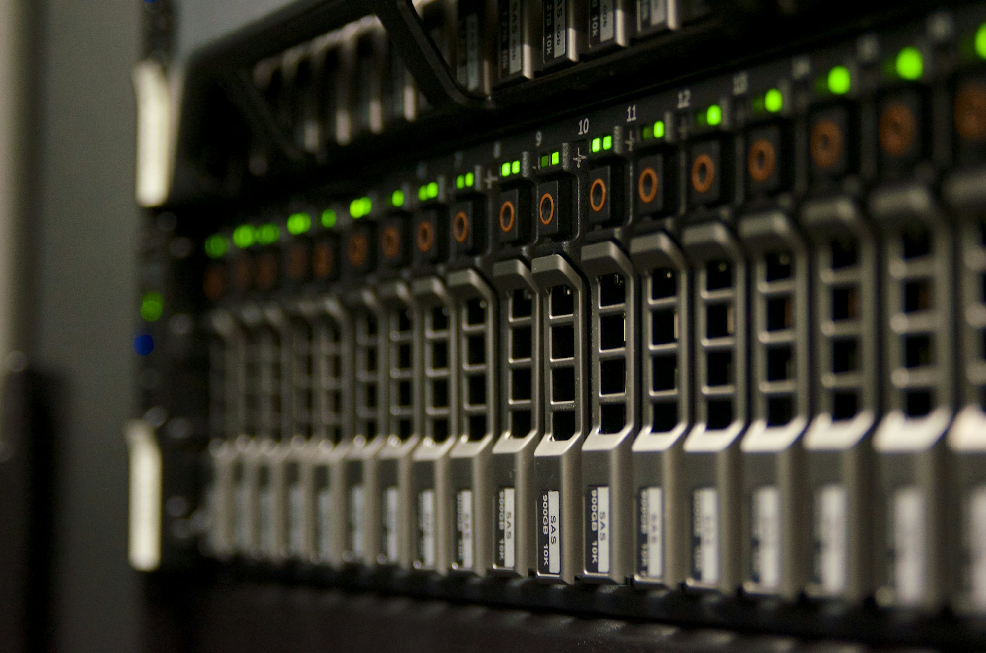 A row of rack servers with green status lights in a data centre